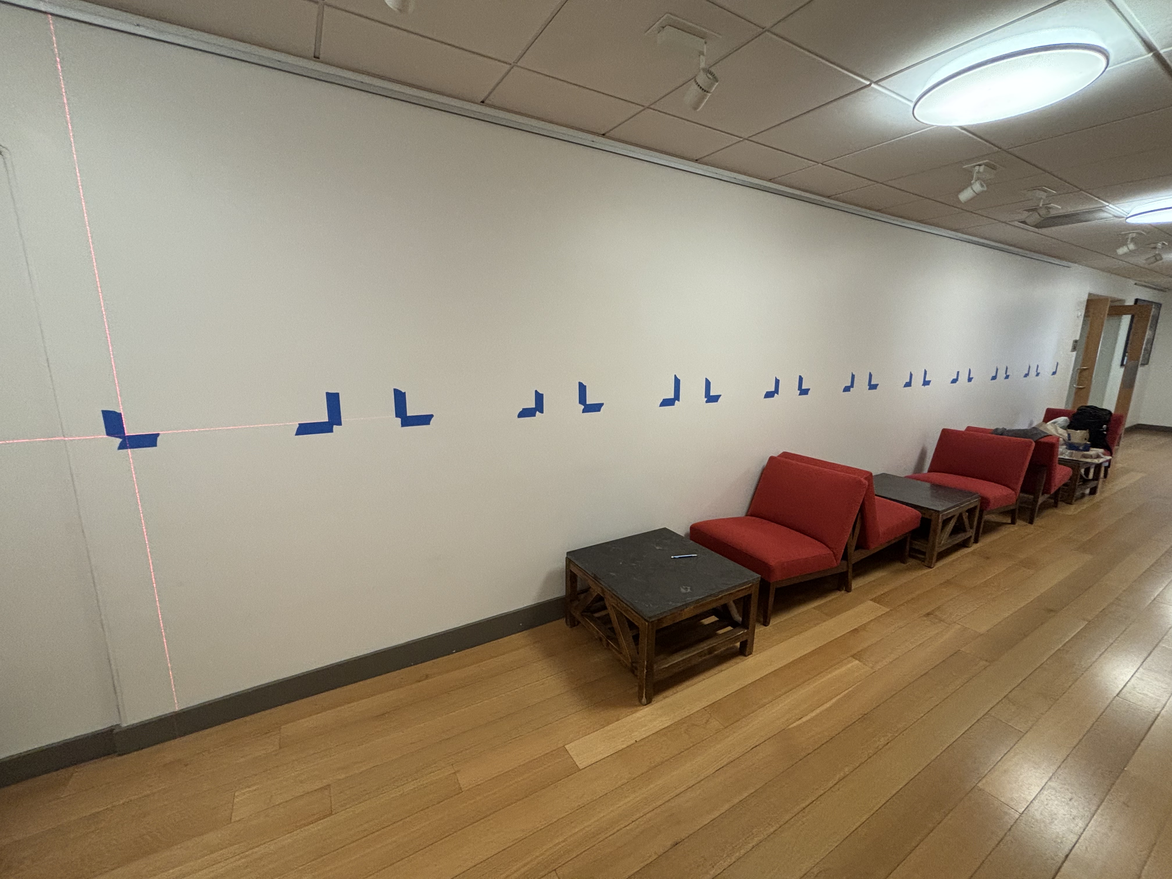 A laser level and some painter’s tape helped with installing the exhibit in the Harvard University Center for the Environment.
